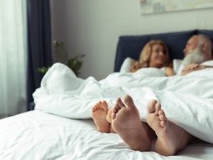 Couple Sleeping In Hotel